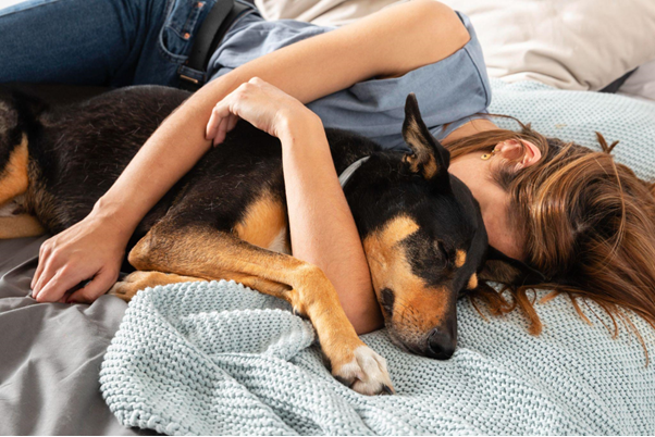 A woman cuddling a dog